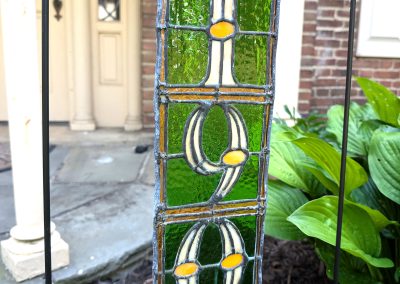 Image of a stained glass street number in green, yellow and orange | Copper & Light Studio